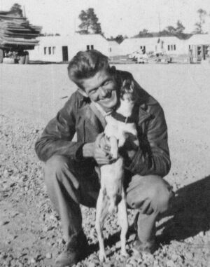 Hamilton poses with a dog at Los Alamos